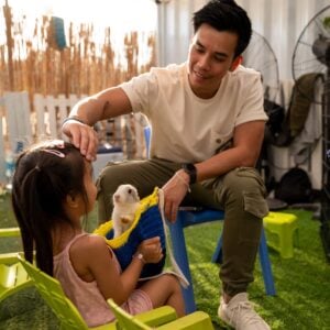 Kid enjoying and petting the rabbit at The Ripe Market - Academy Park Dubai -