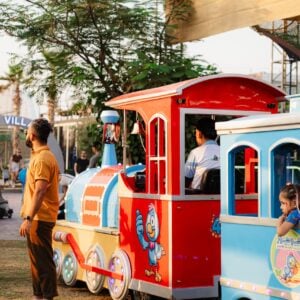 Kids getting ready for train ride at The Ripe Market - Academy Park Dubai.