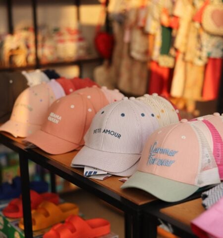 Display of colourful caps and kids’ accessories at a stall at The Ripe Market, Dubai Hills Golf Club.