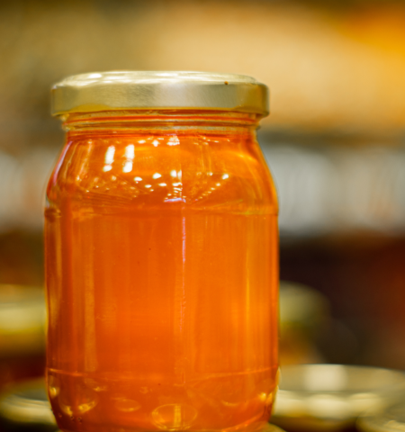 Close-up of a glass jar filled with golden artisan honey displayed at The Ripe Market City Walk Pop-Up 2026 in Dubai.