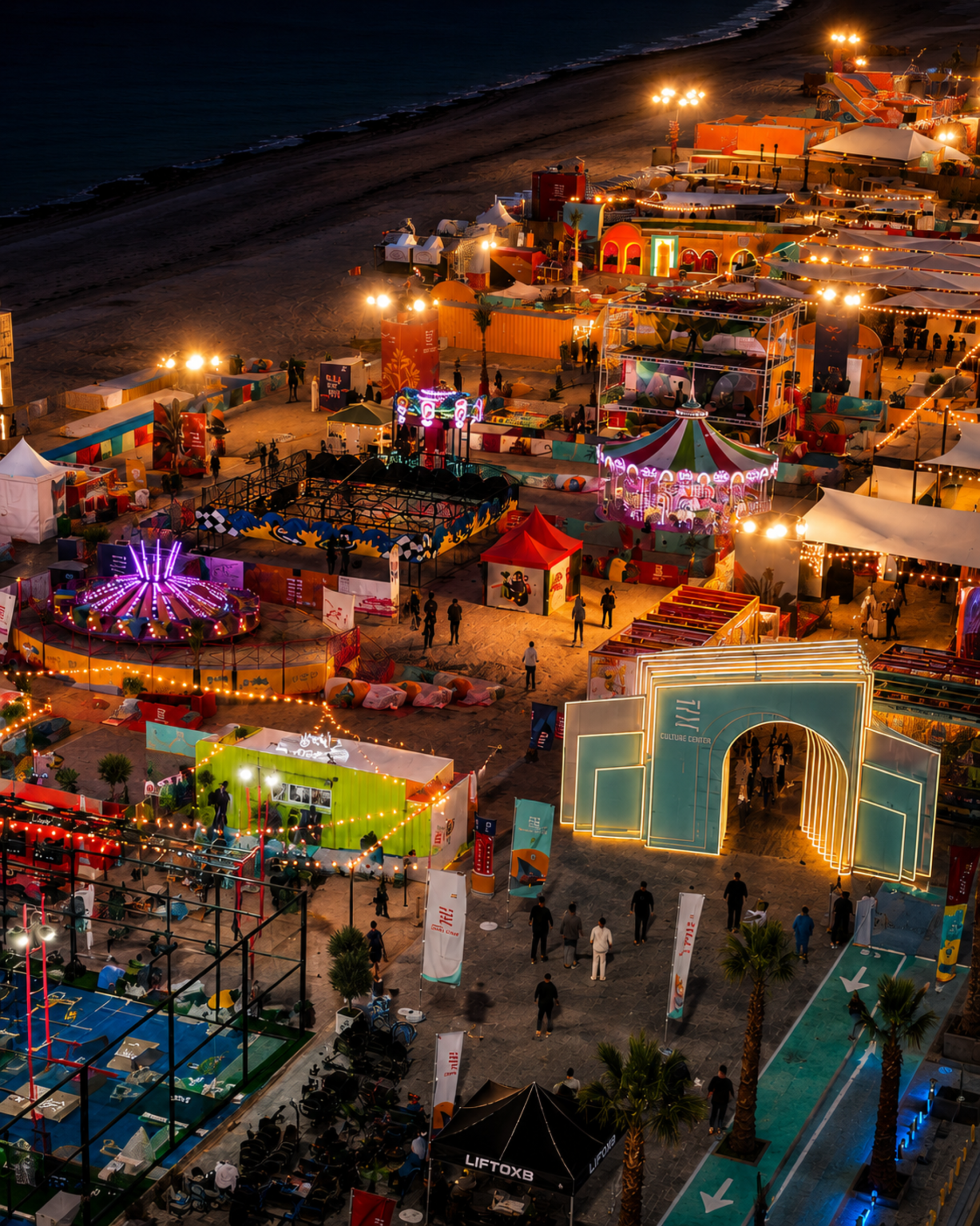 Aerial view of a large-scale beachfront festival at night featuring entertainment stages, amusement rides, food concepts, interactive attractions, and public event infrastructure produced by Ripe Events.